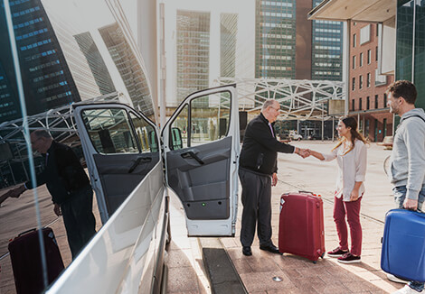 Taxi driver greeting passengers